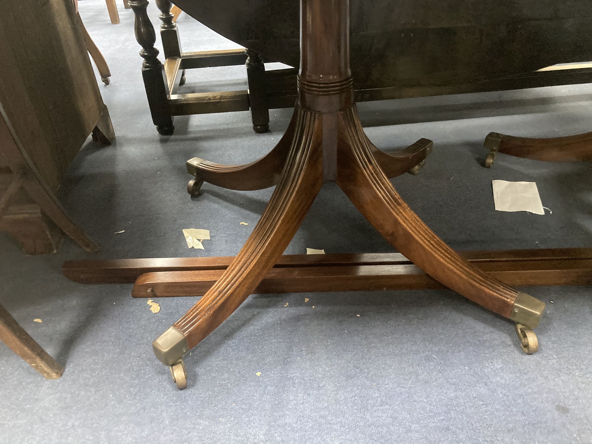 A George III style mahogany twin pedestal dining table, with two spare leaves, length 175cm, depth 106cm, height 71cm